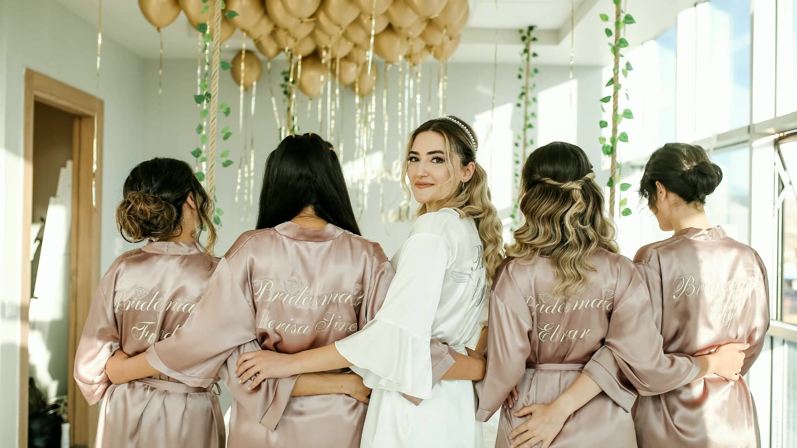 Bride and bridesmaids in champagne robes at a Las Vegas bachelorette