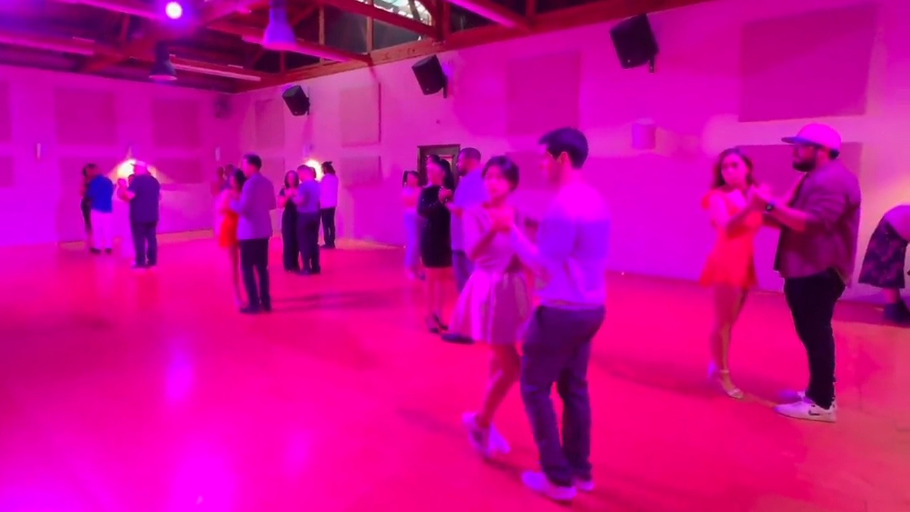 Group salsa class practicing partner work in pairs — real footage from our Salsa Dance LA family