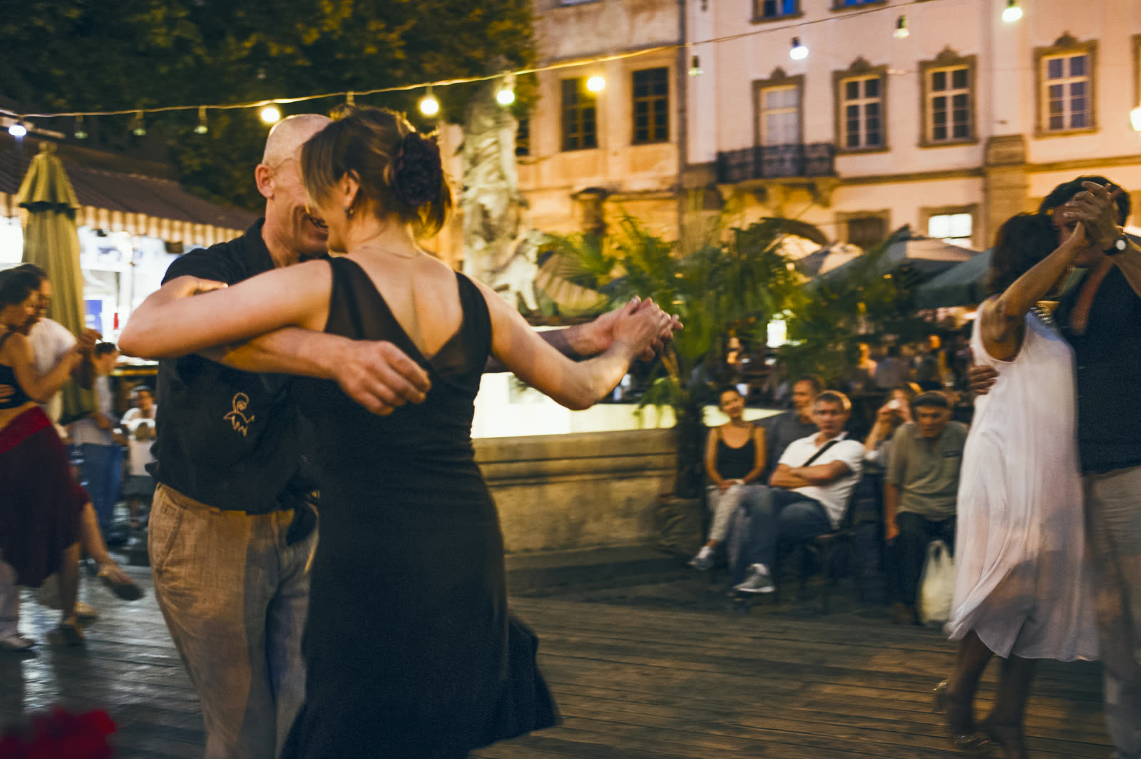Couple dancing under string lights on a Las Vegas date night