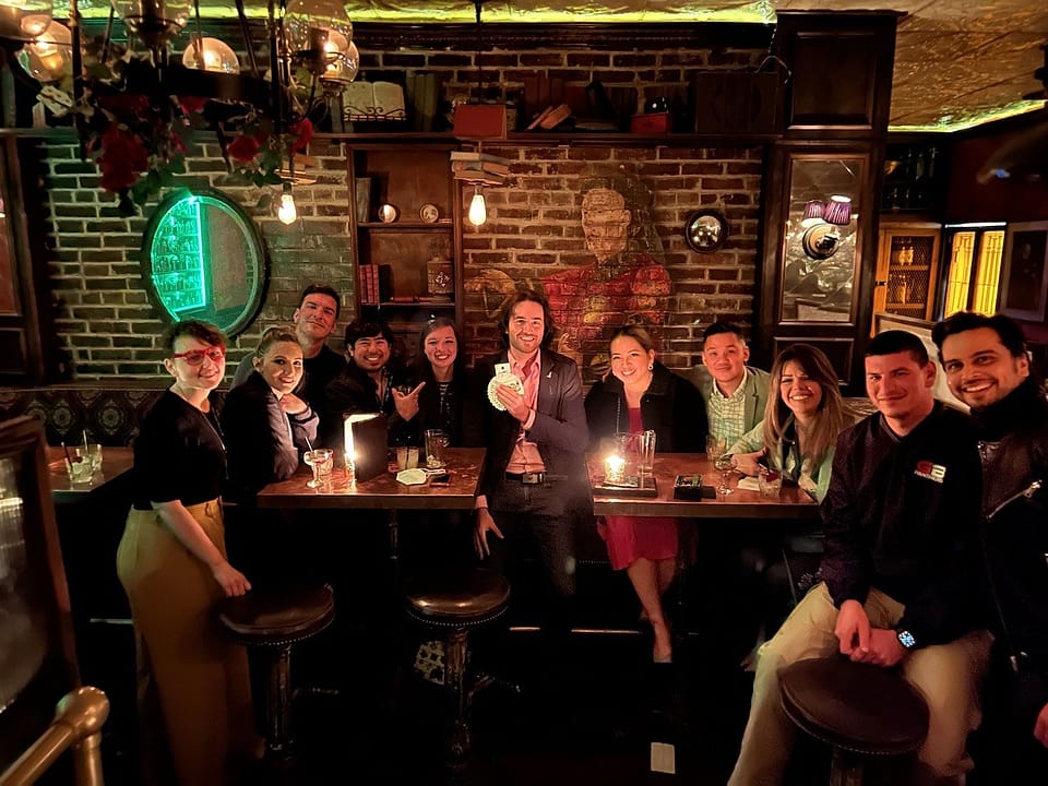 A group around a candlelit table on a hosted speakeasy night