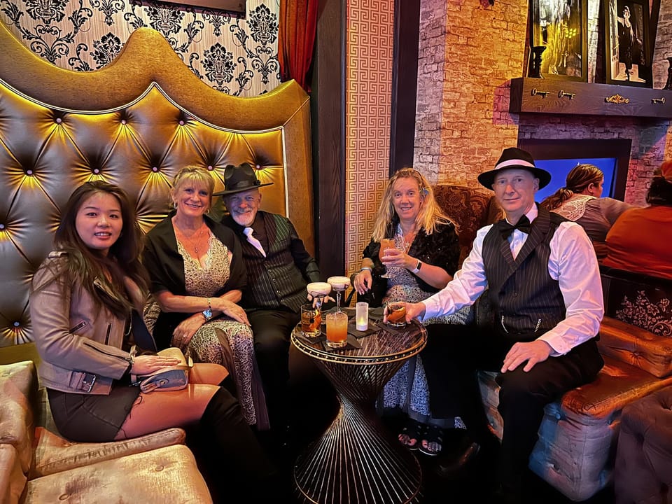 A group in a gold velvet booth on a hosted Las Vegas night out