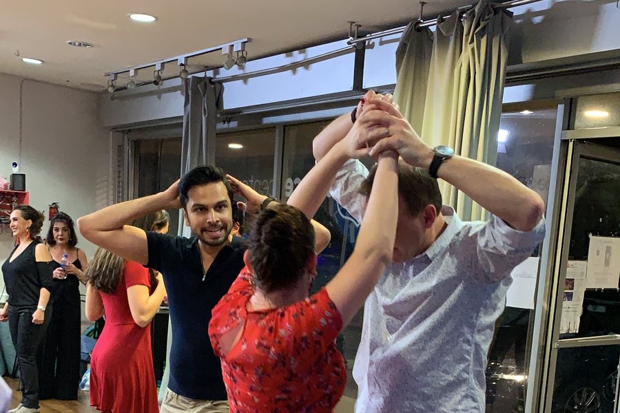 Avissh Trivedi teaching a couple a salsa turn during a private lesson