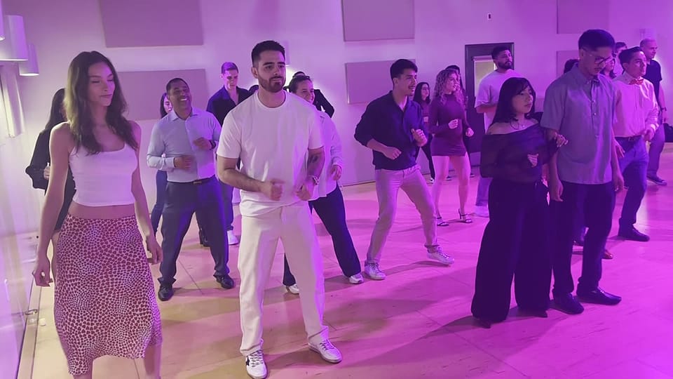 A full room of couples in lines learning salsa at Rhythms & Romance in Los Angeles
