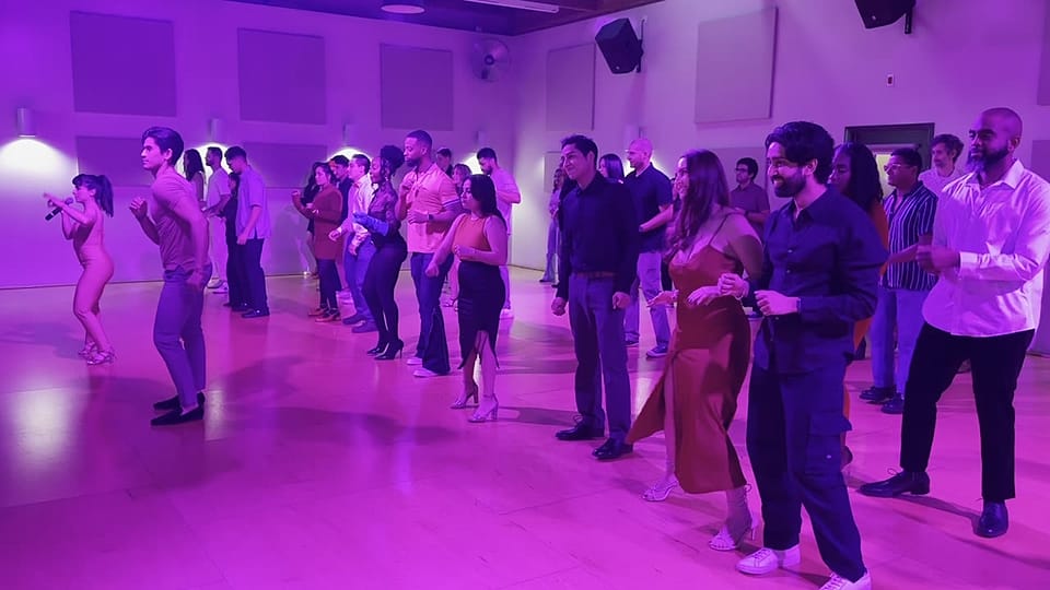 A crowded dance floor of beginners learning together
